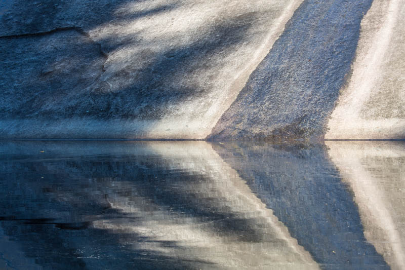 Rock Face Reflected In Pool